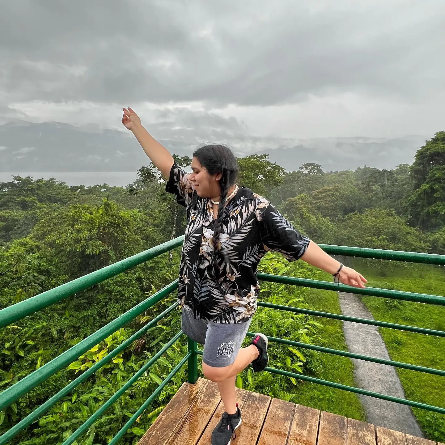 Cessia Gonzalez on a balcony in a tropical forest.