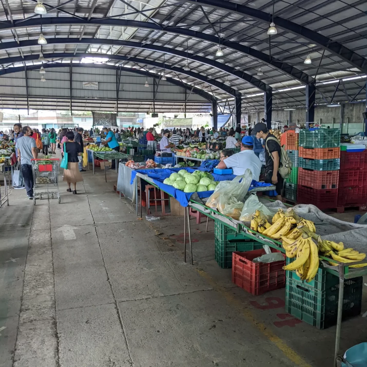 Inside a building where food and clothing are being sold.