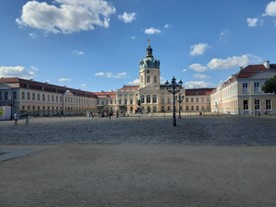 An old-style white building with red roofs.