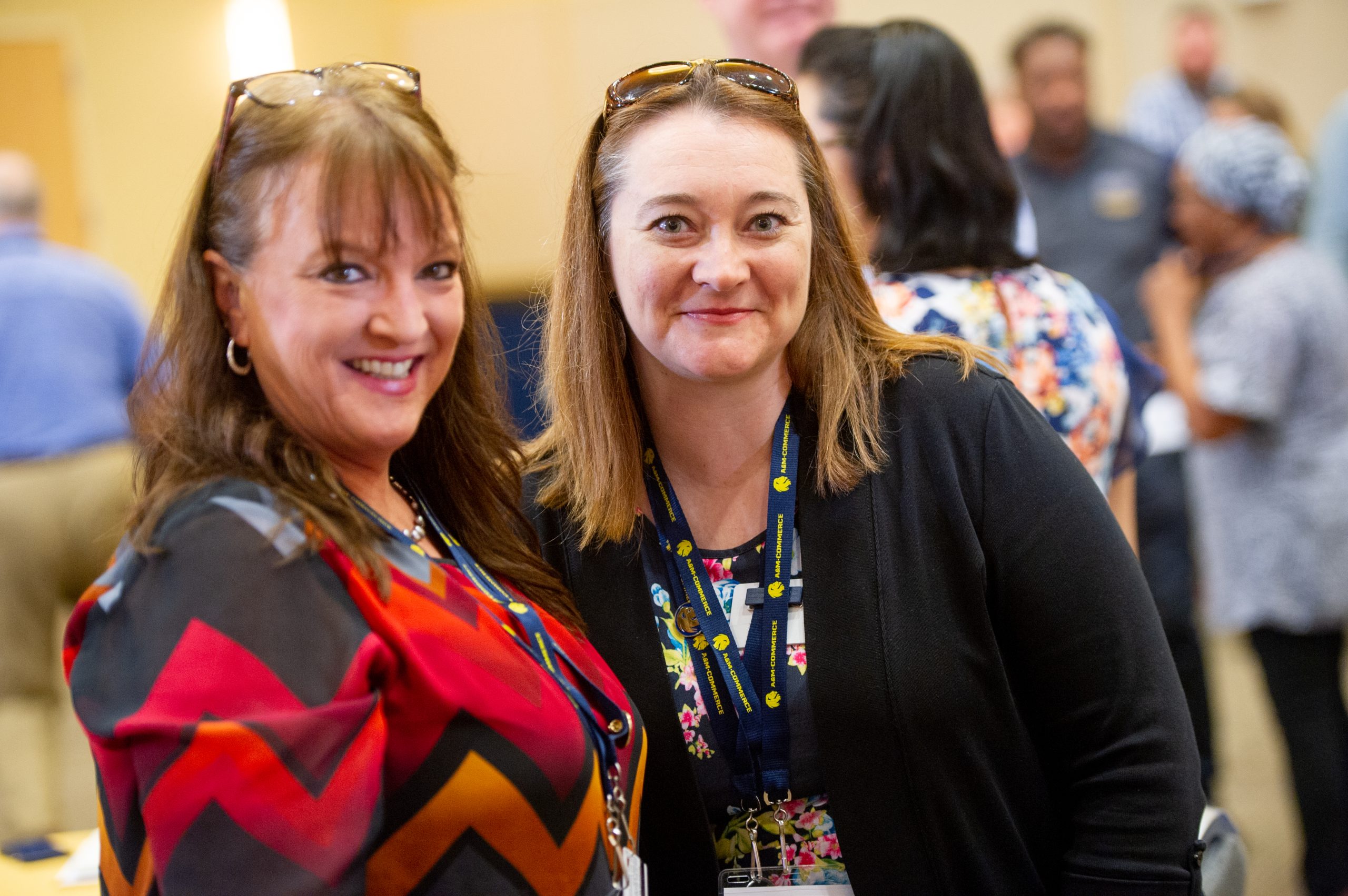 Two female smiling at the camera man.