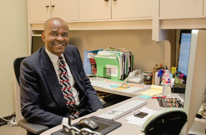 Eges Egedigwe in his office smiling.