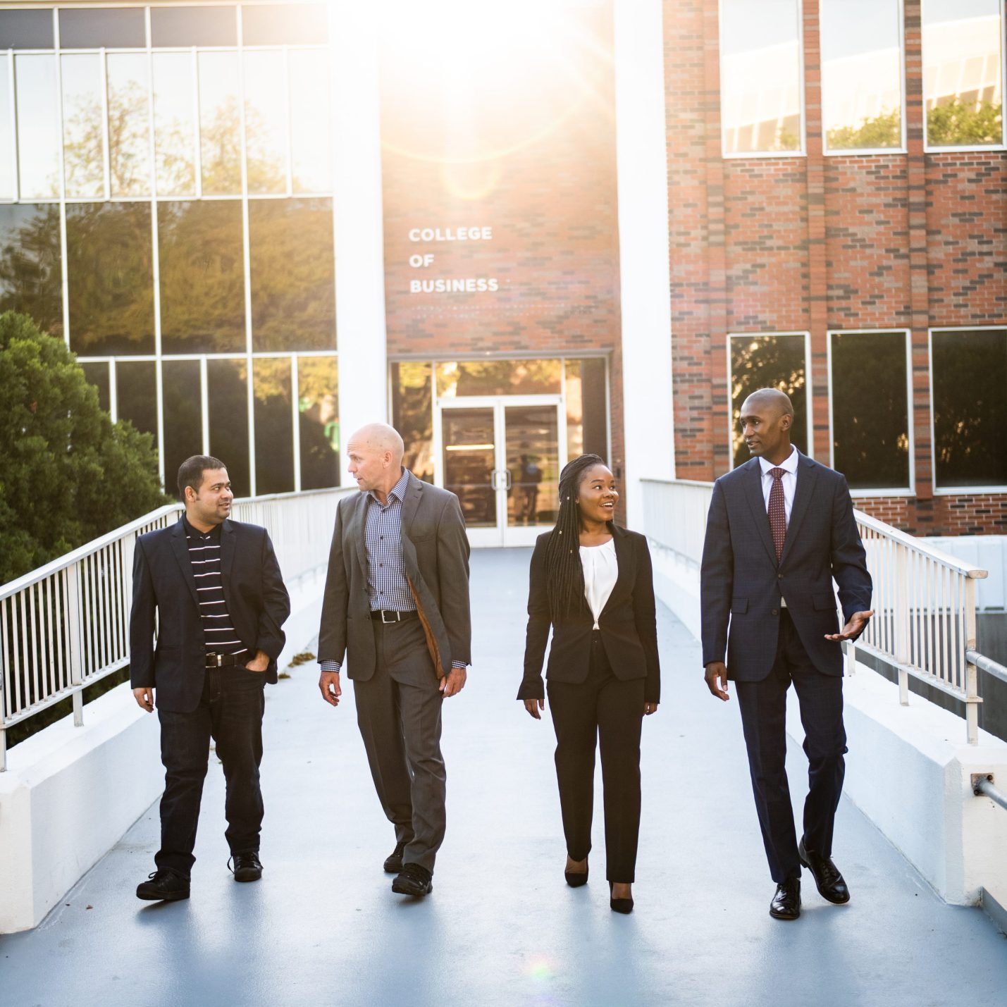 Four business student leaving the BA building.