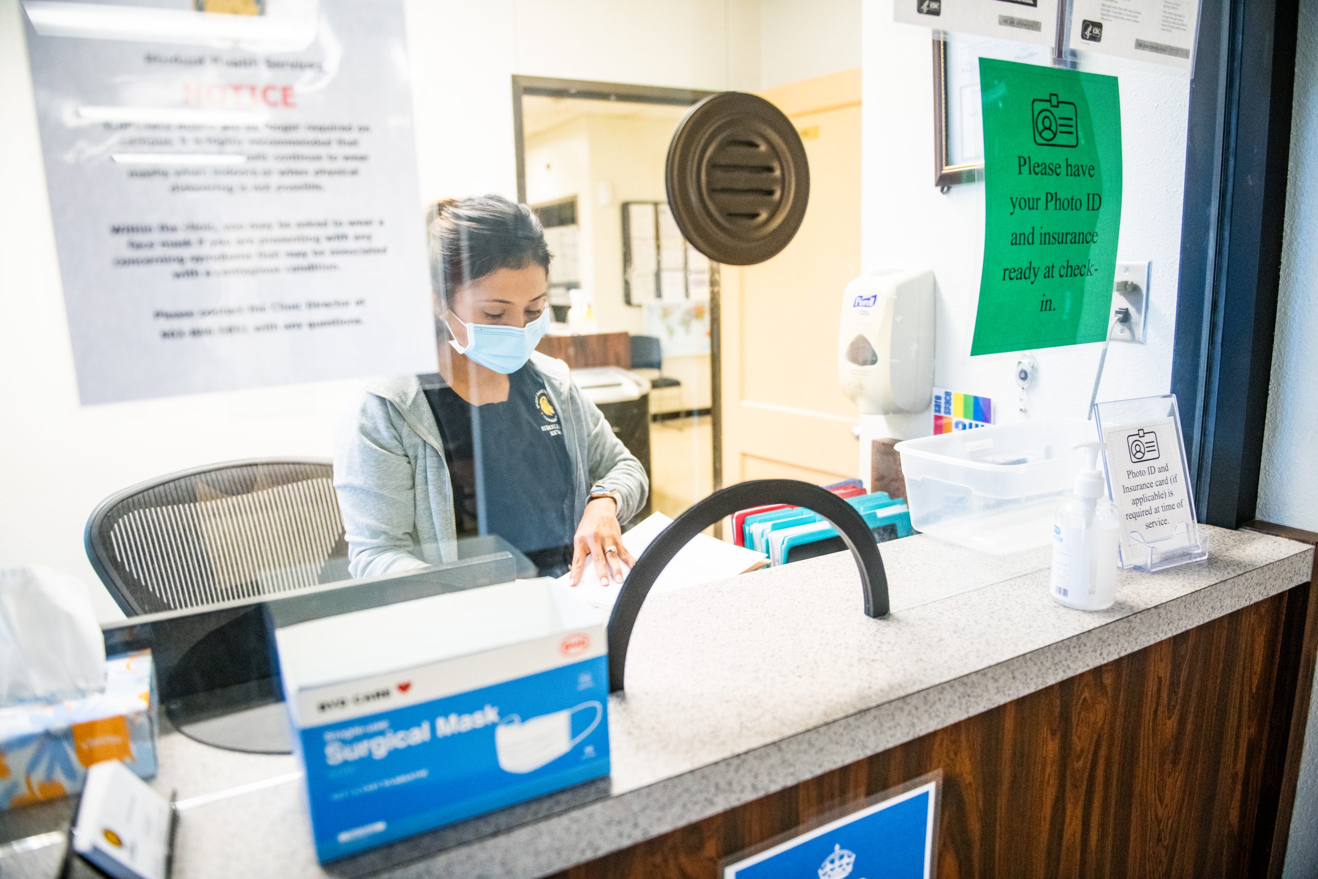 A female nurse at the reception area.