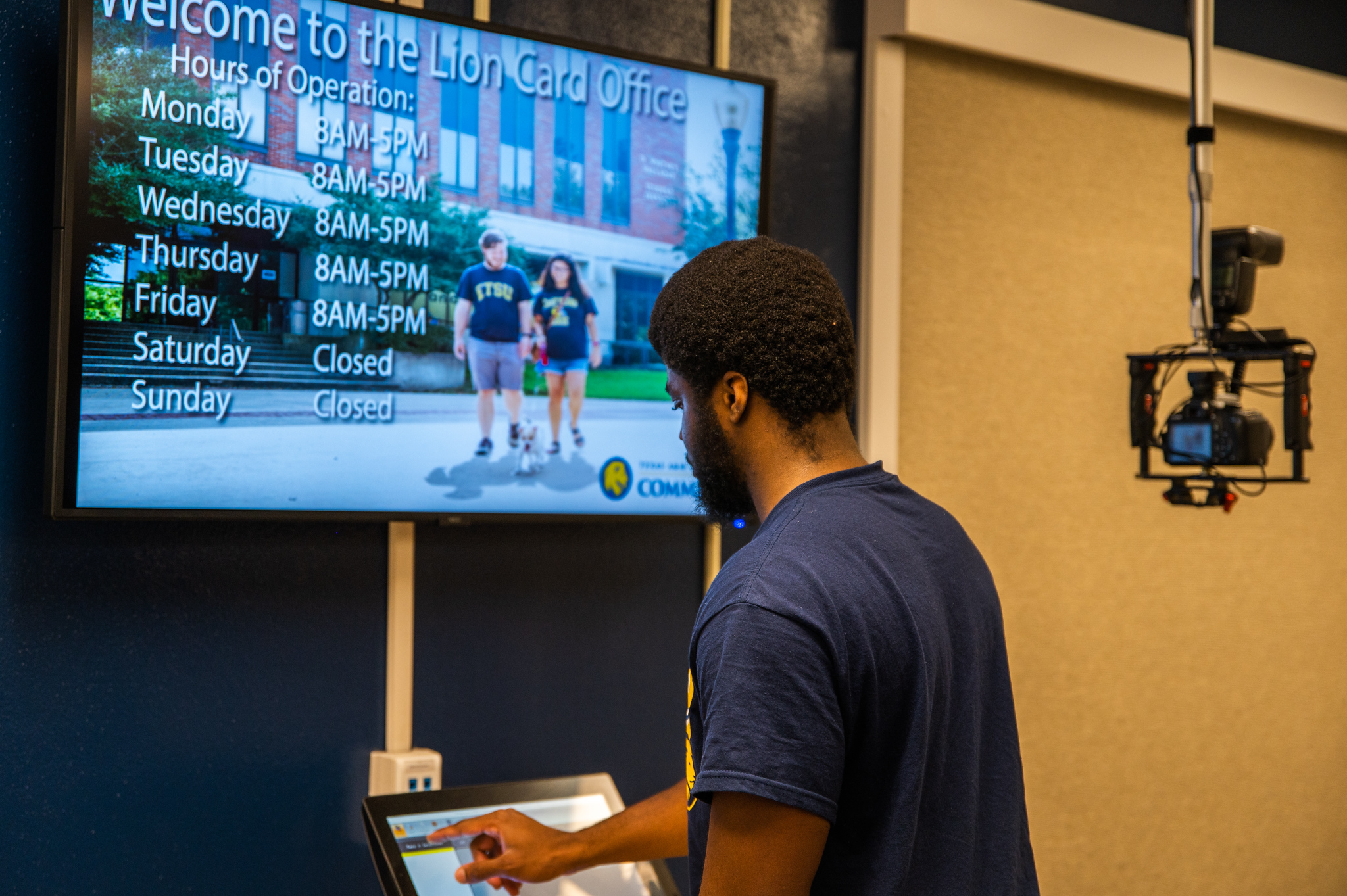 Student processing Lion Card in office