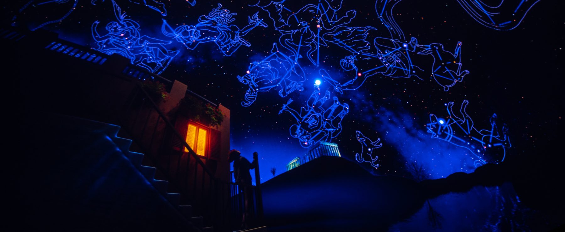 A planetarium show depicting a person looking at constellations in the sky.