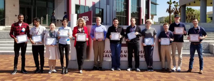 Students pose with their award certificates.