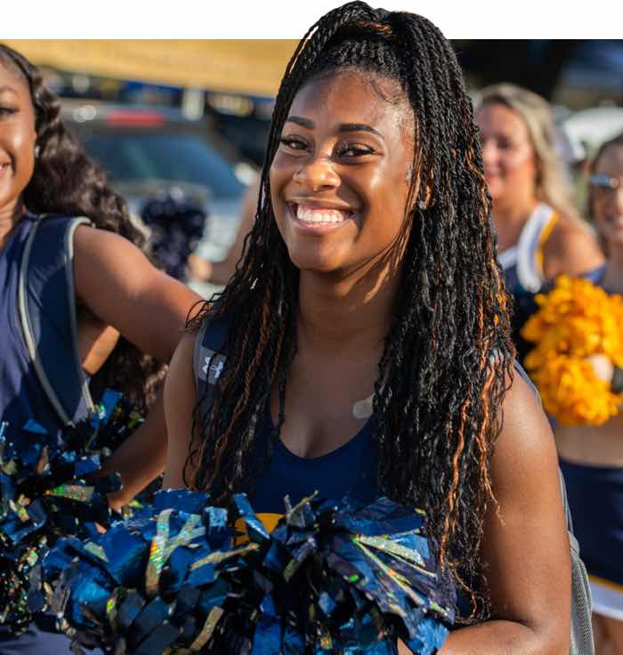 TAMUC Cheerleader smiling at the camera.