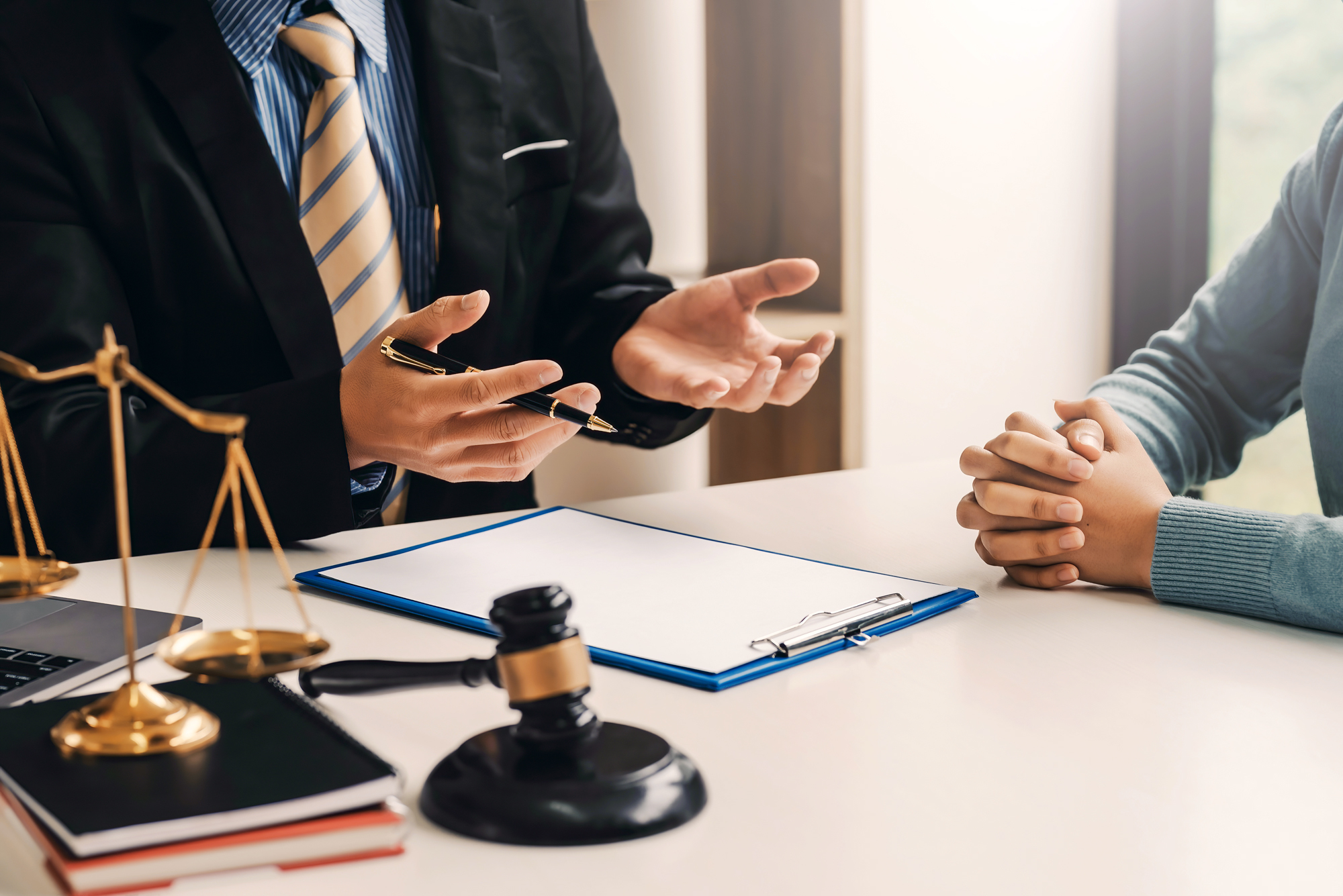 A lawyer speaking with a client about something in an office.