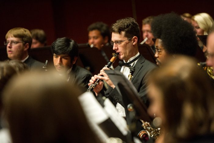 A group of students playing the clarinet.