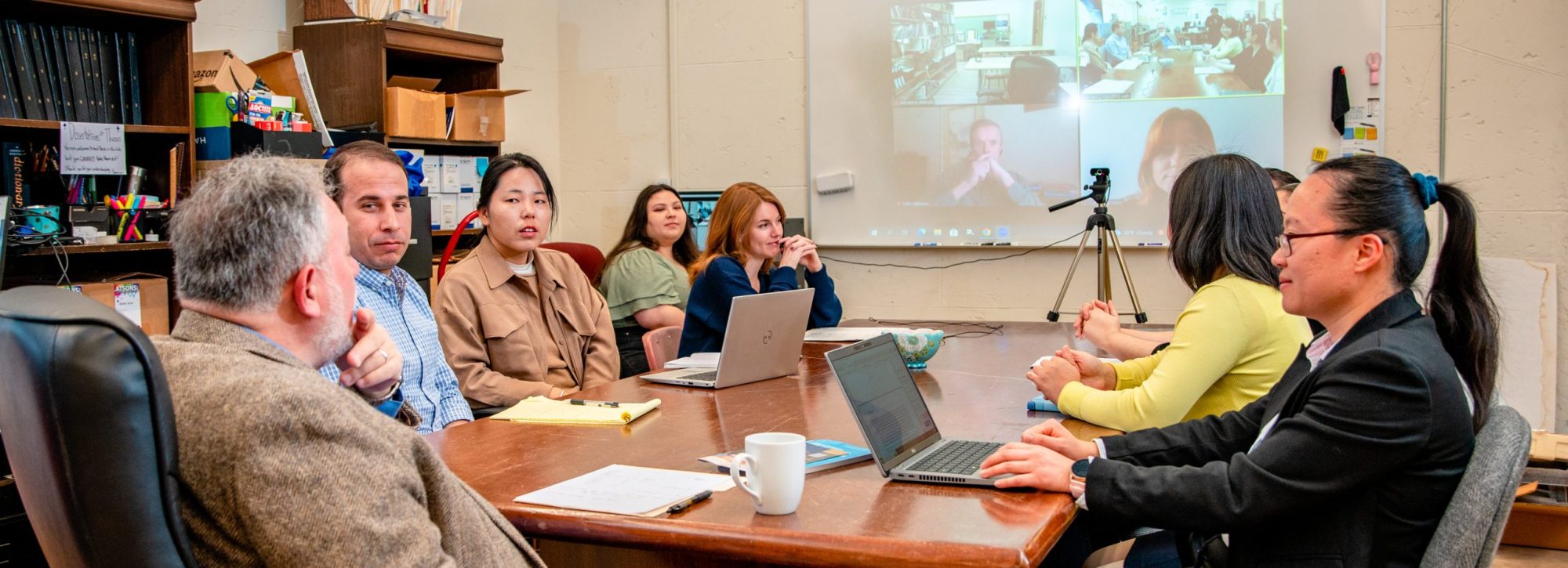 A group of students speaking to a professor.