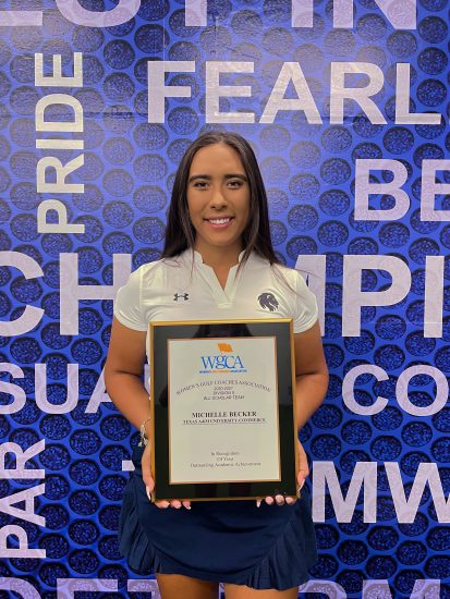 A person holding an award plaque