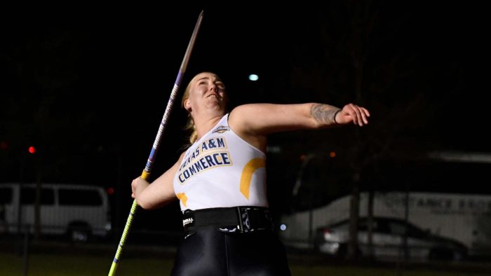 Athlete leans back, preparing to throw the javelin.