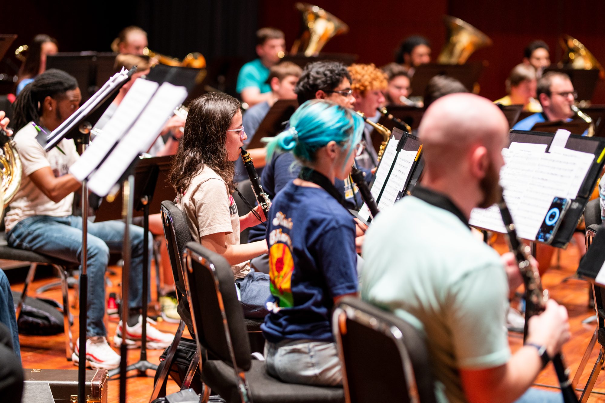 A group of students in the classroom playing clarinet.