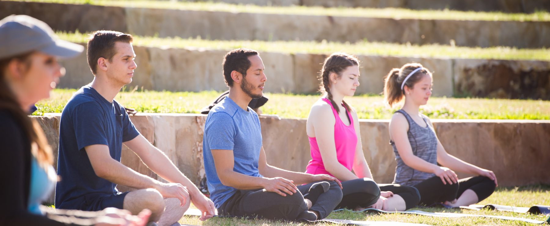 Students meditate on the outdoor amphitheater lawn at A&M-Commerce