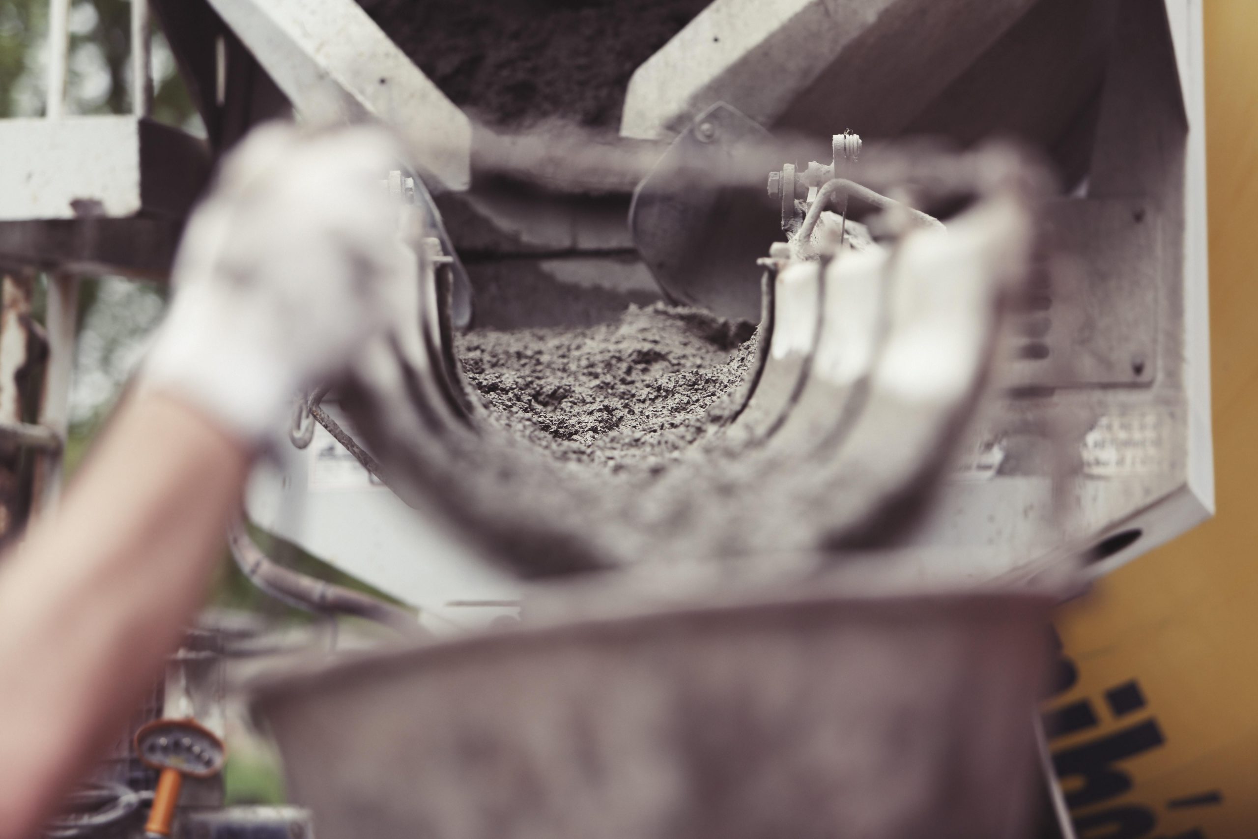 Concrete truck pouring concrete in a bin.