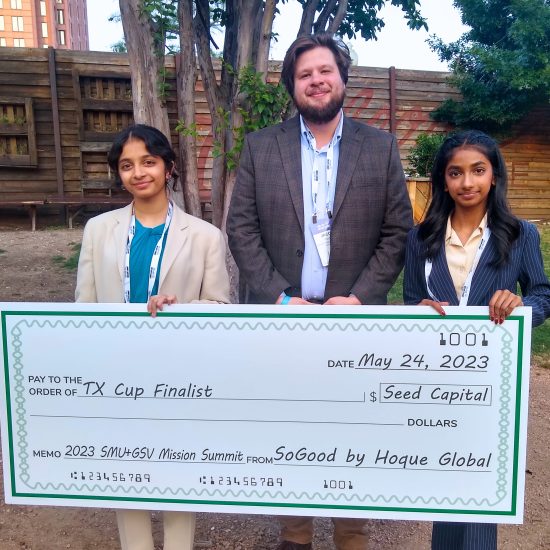 Three people posing with a giant novelty check.