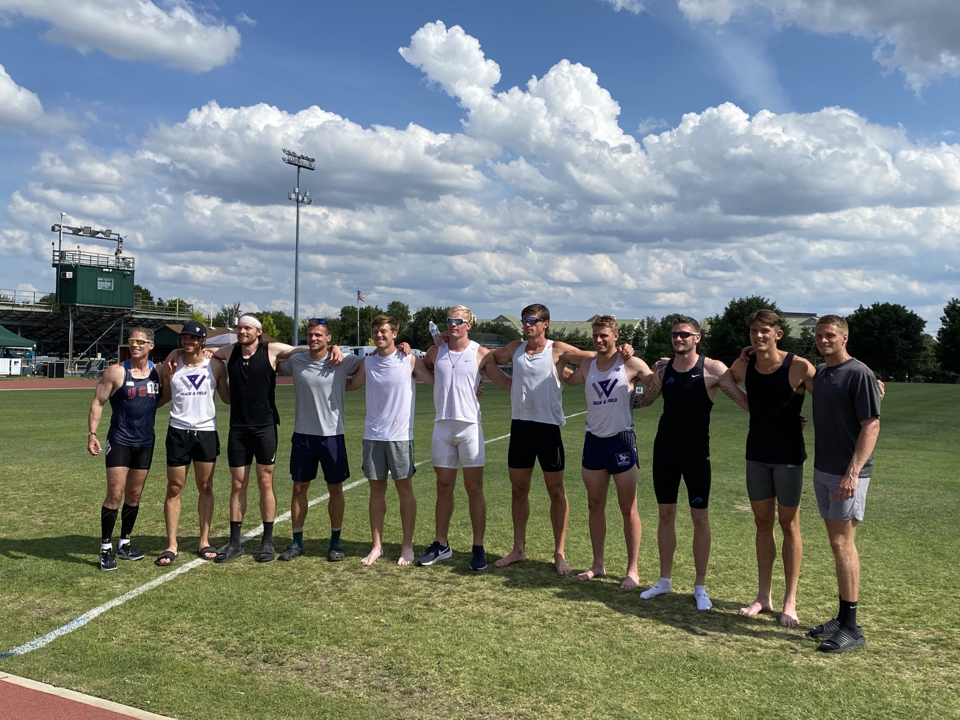 Several male athletes pose for a group shot.