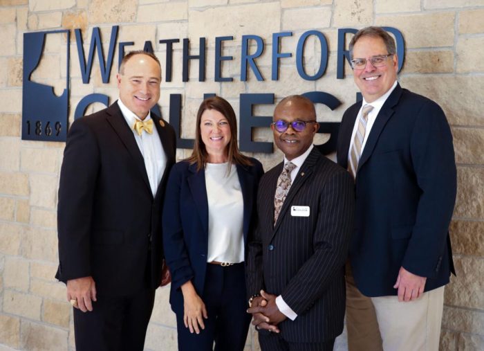 Two administrators from Weatherford College stand beside two administrators from A&M-Commerce.