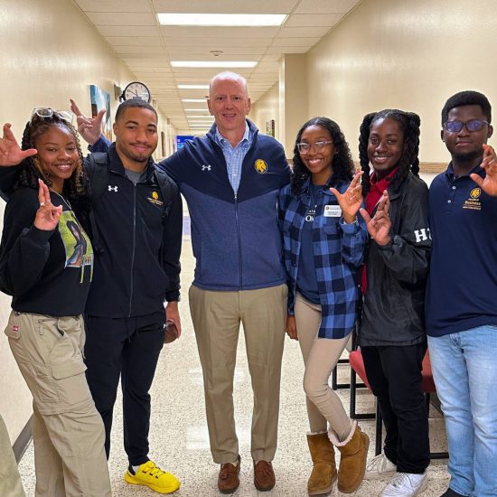 A group of students taking a picture with their professor