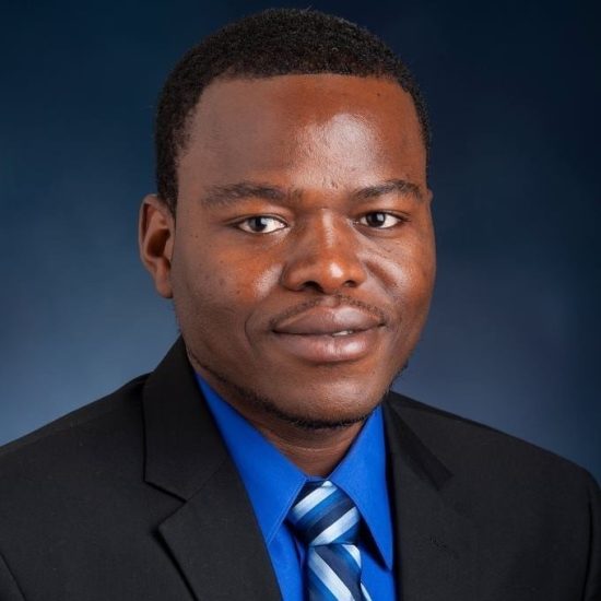 A headshot photo of a person wearing a suit.