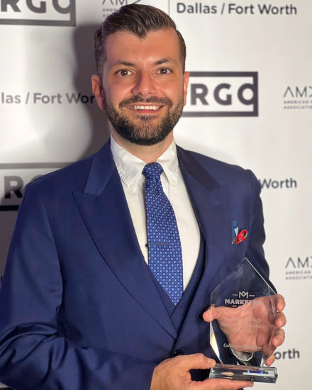 A person holding an award trophy