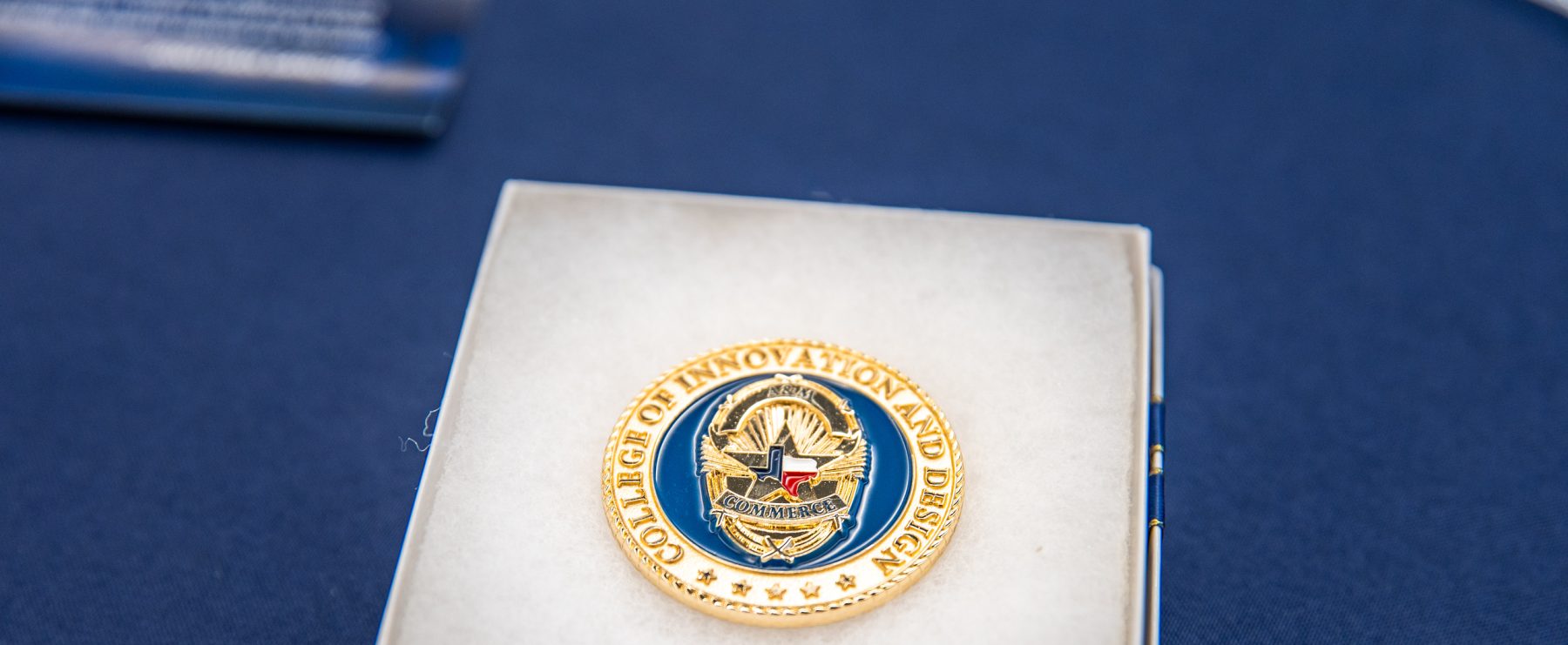 A commemorative coin inside a jewelry box.