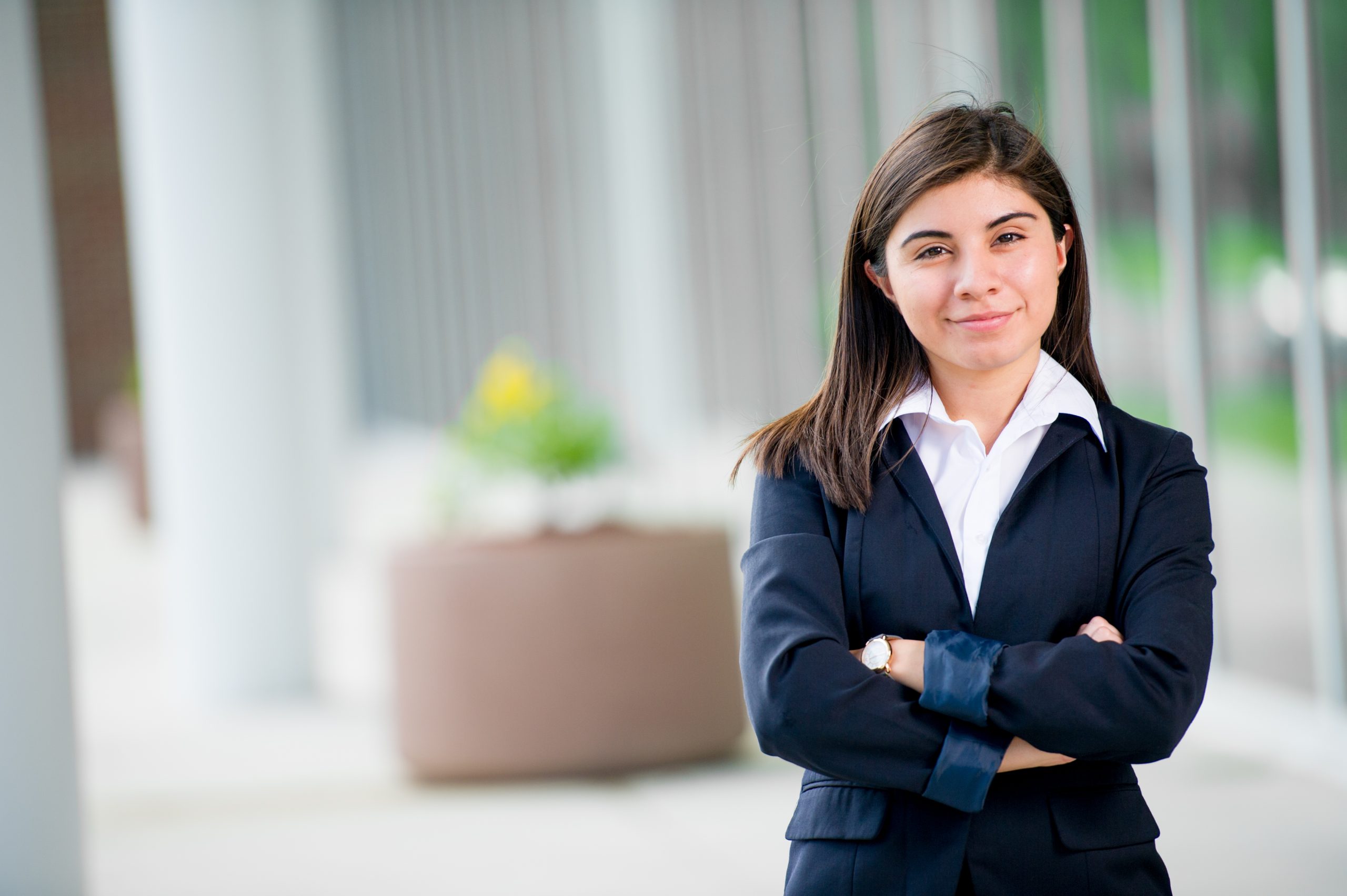 A female in a business suit posing.