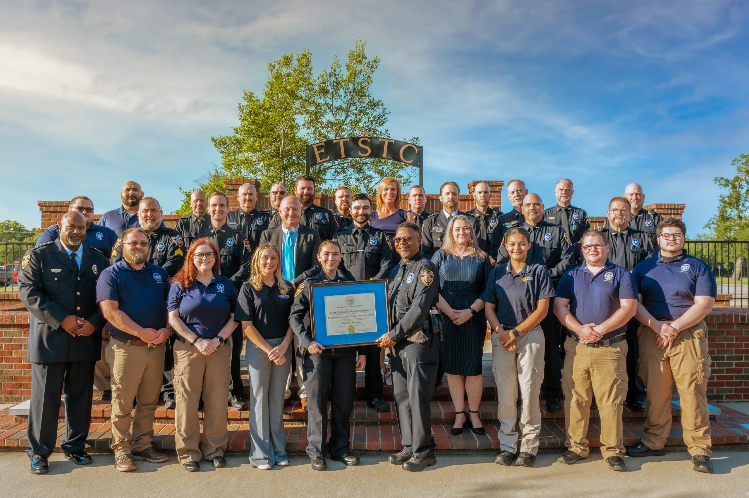 A group of males and female who are a part of the police department.