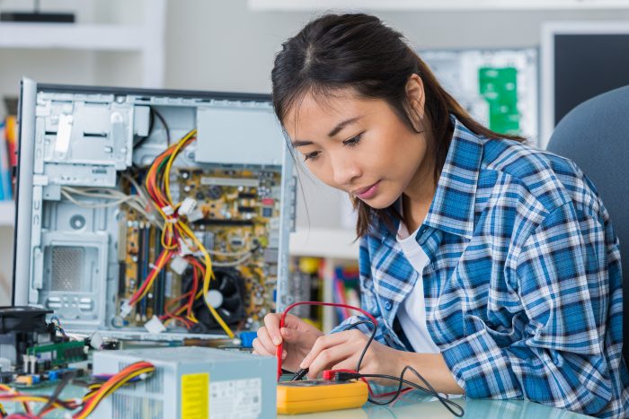 student girl in technology fixing computer hard drive