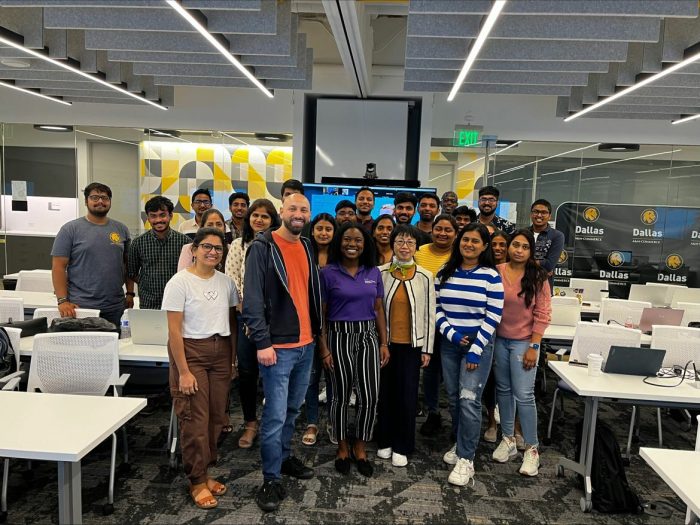 A group of people pose for a photo indoors.