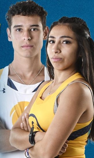 Two cross country athletes with arms crossed, looking at camera