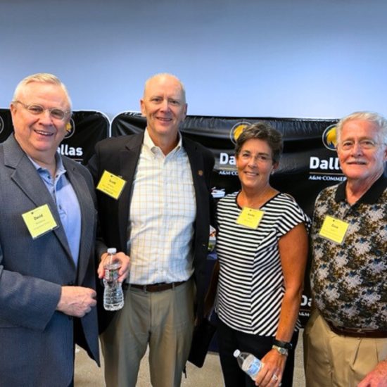 A group of four people pose for a photo