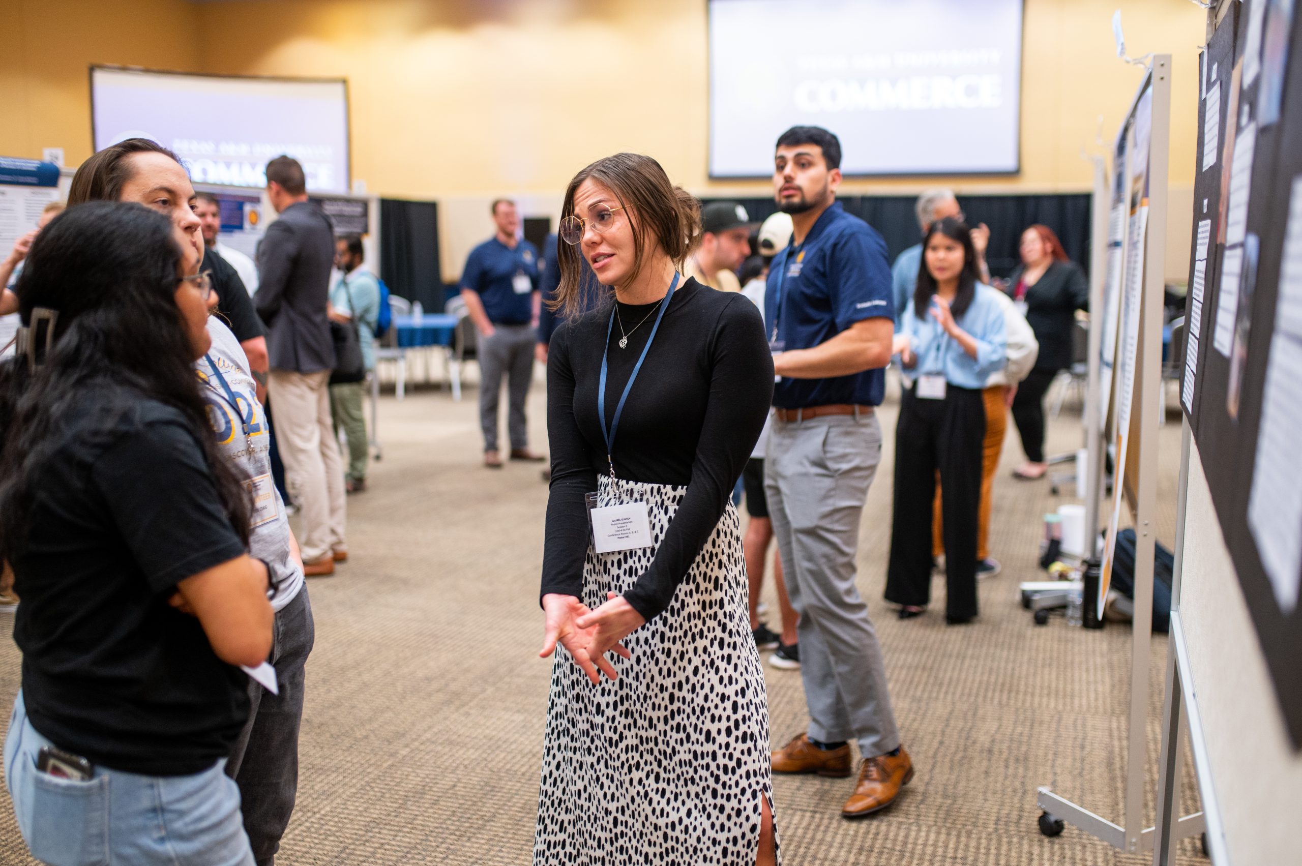 A female student speaking with potential new students.