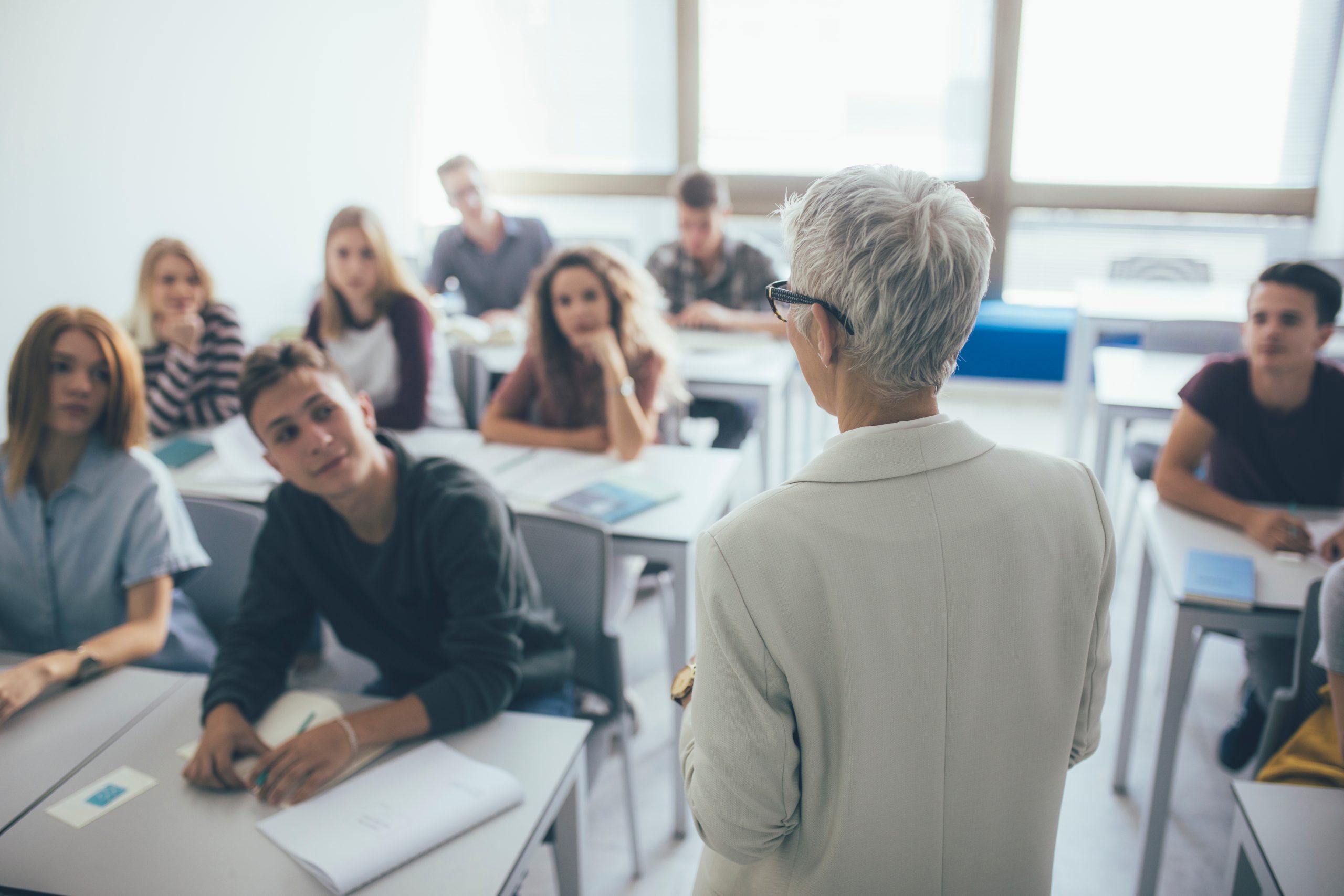 Teacher Teaching a Lesson to college students.