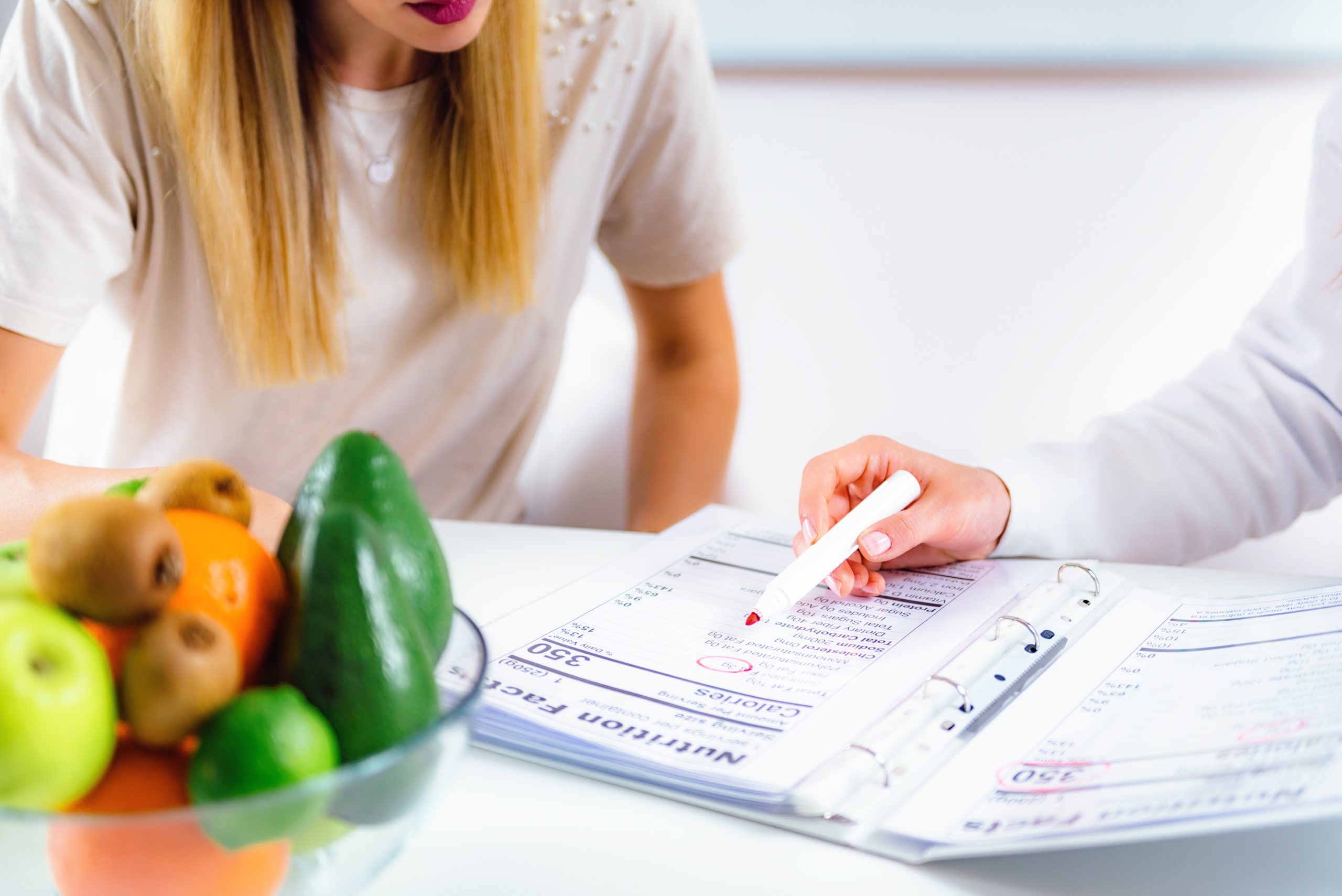 Doctor nutritionist, dietician and female patient on consultation in the office