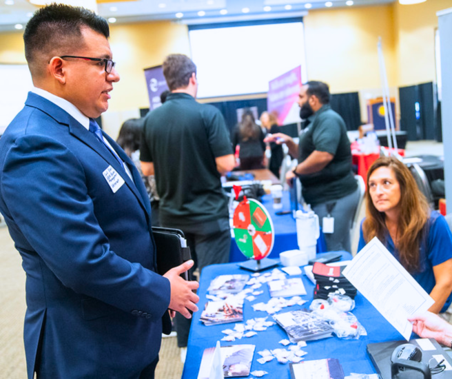 People speaking at a career fair.