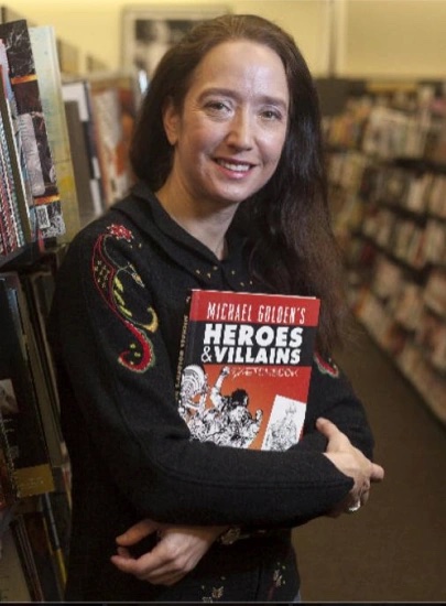Renée Witterstaetter holding a comic book in her arms