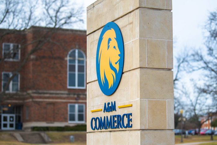 A vertical stone pillar displays the A&M-Commerce logo.