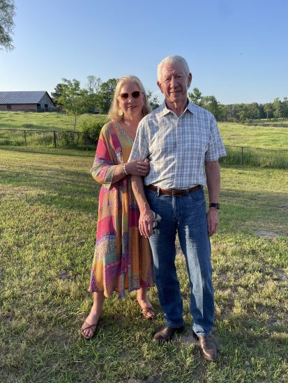 Couple stands in the countryside