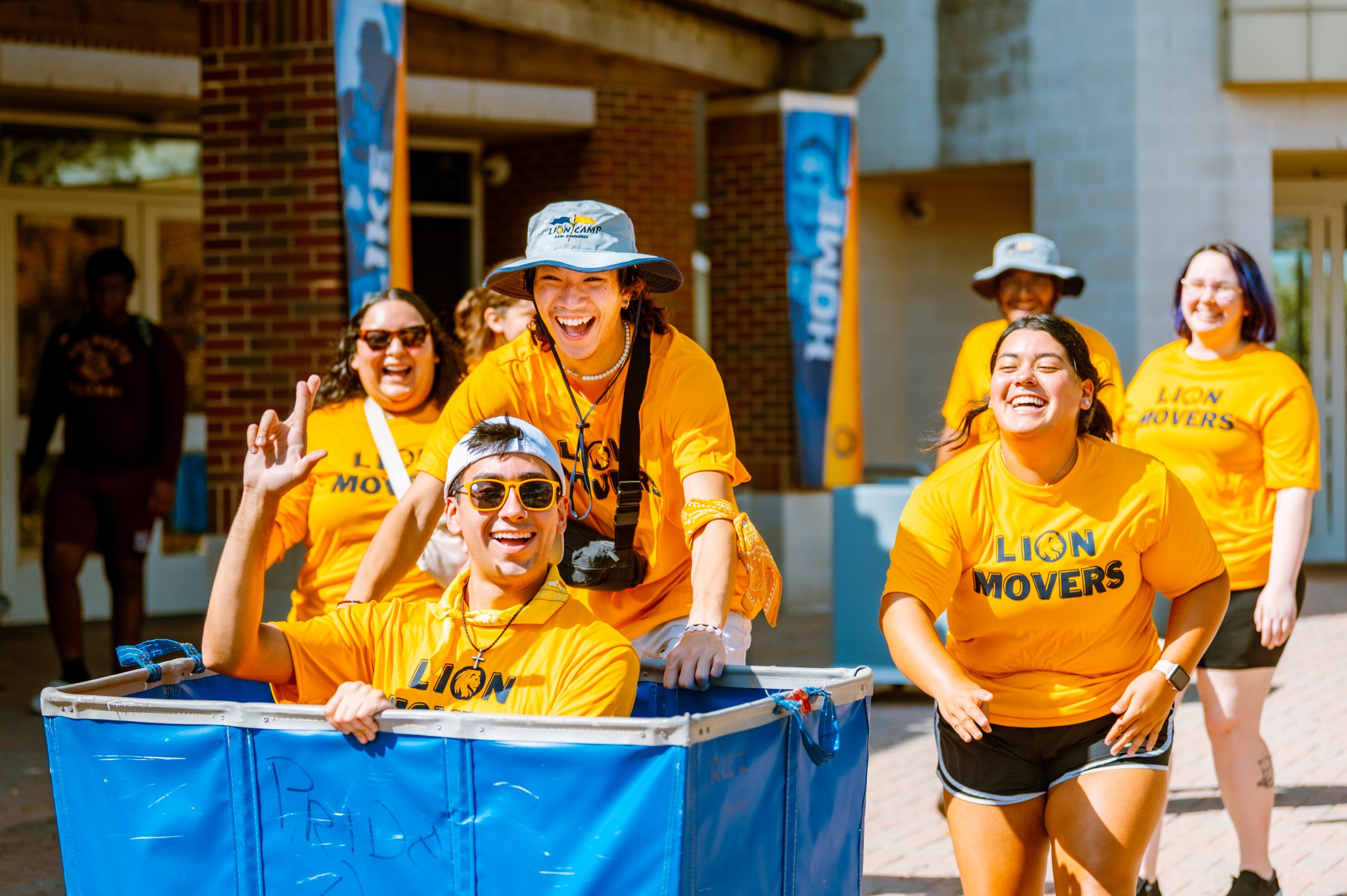 A group of students with Lion movers t-shirt walking some where.