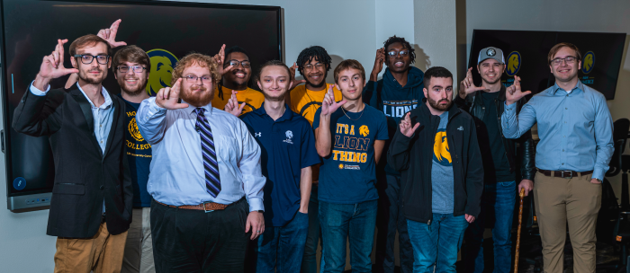 A group of people stand and pose for a photo