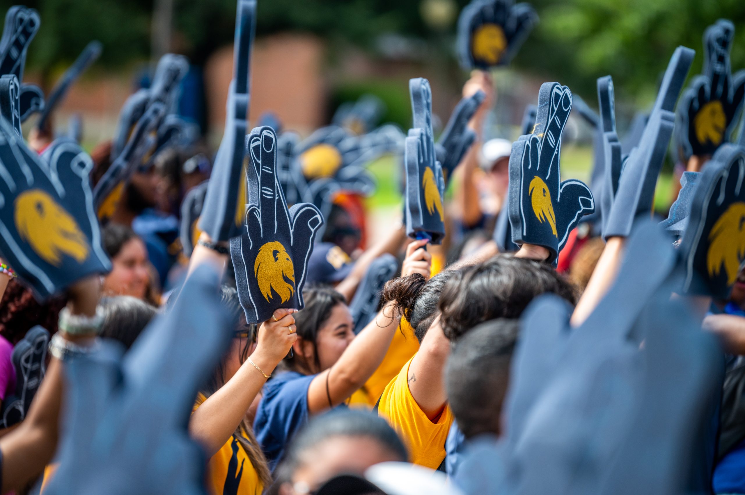 A group of students with foam finger outside.