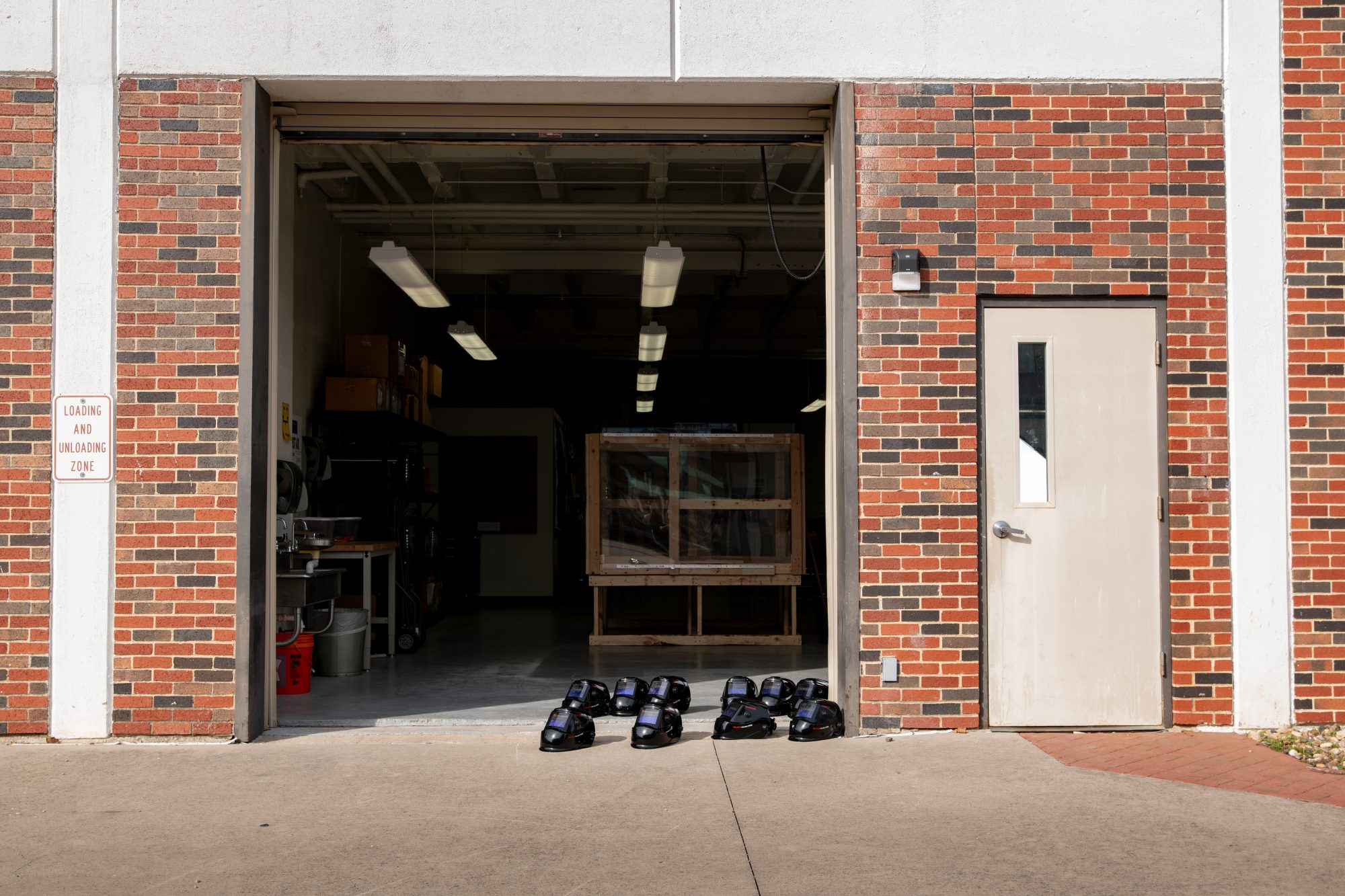 A garage door with eye protective on the floor.