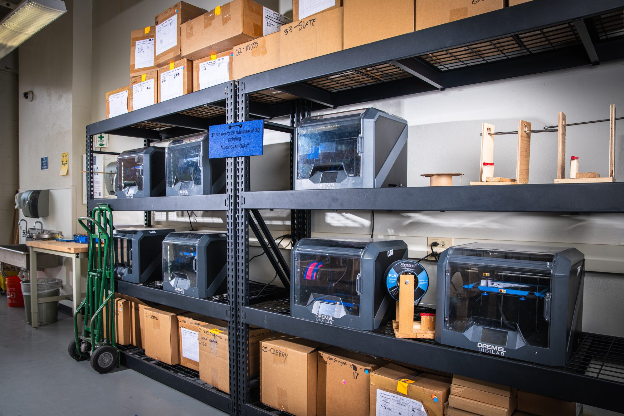 A wall filled with shelves that have boxes and digital lab.