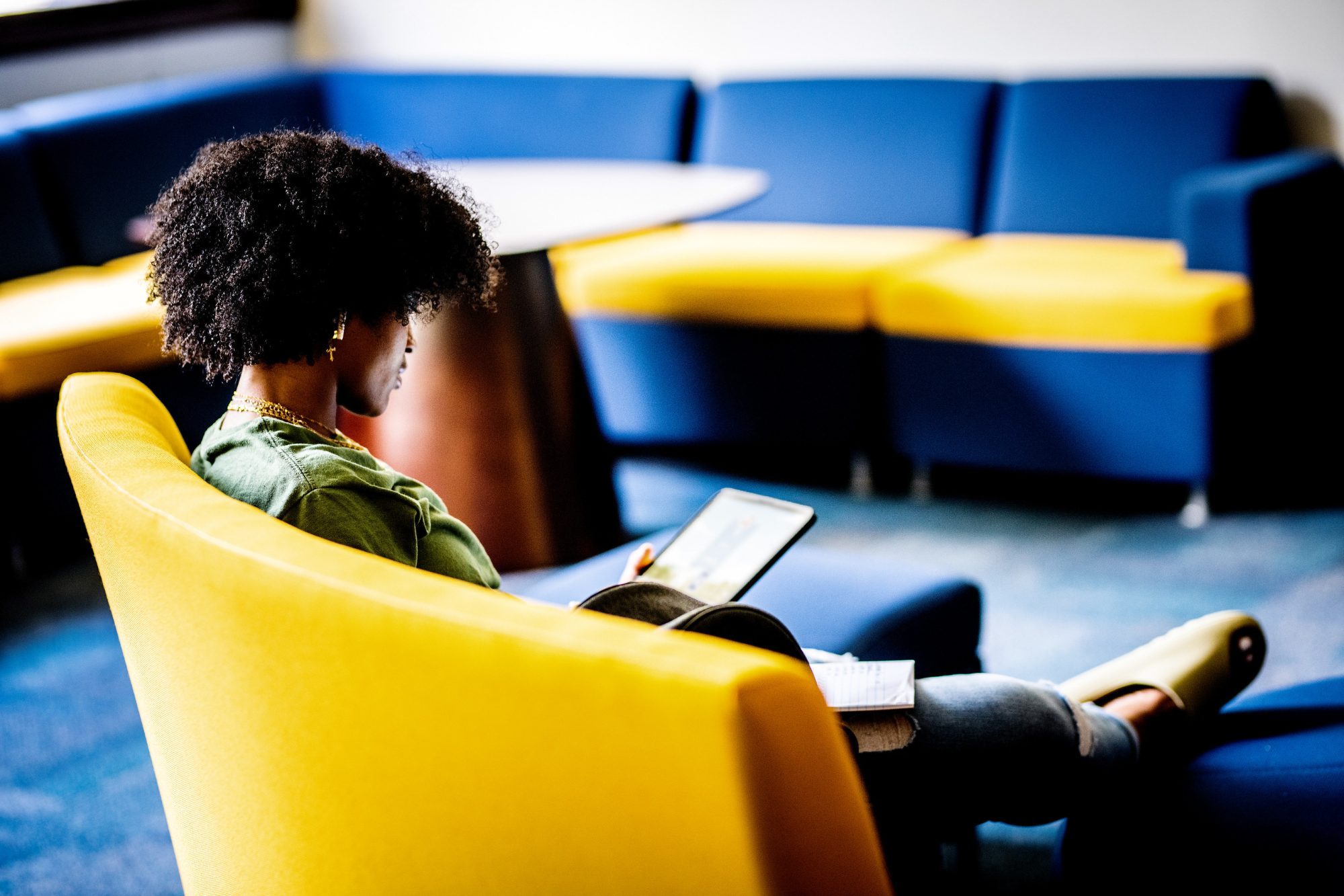 A student works on their tablet in the Talbot Hall lounge at A&M-Commerce.