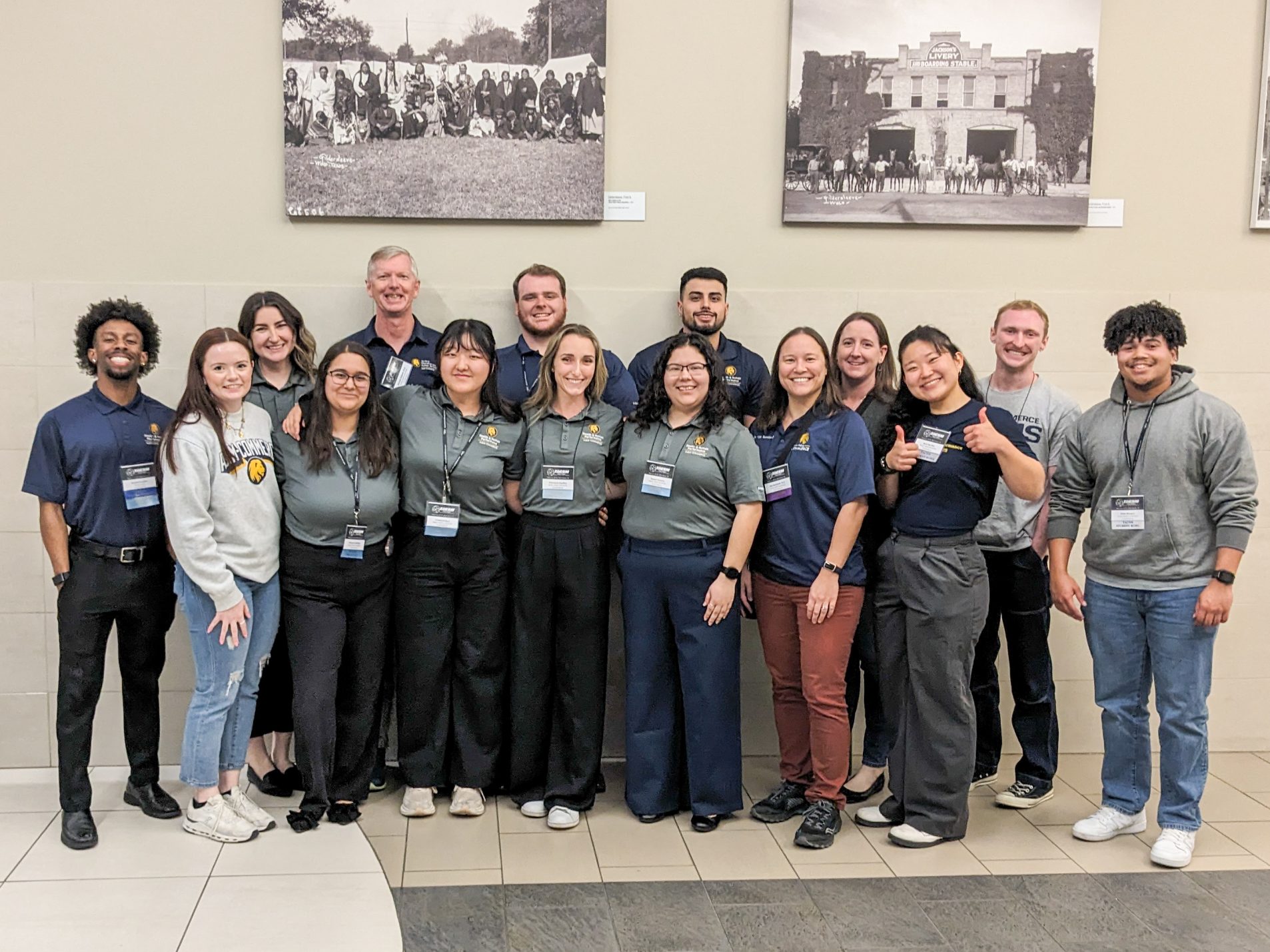 A group of faculty and students pose for a picture.