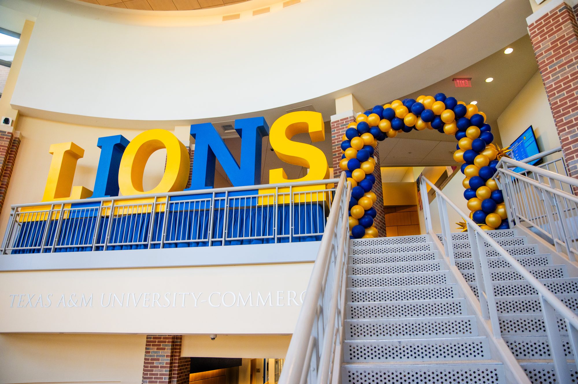 A staircase with lion at the top on it and balloons. 