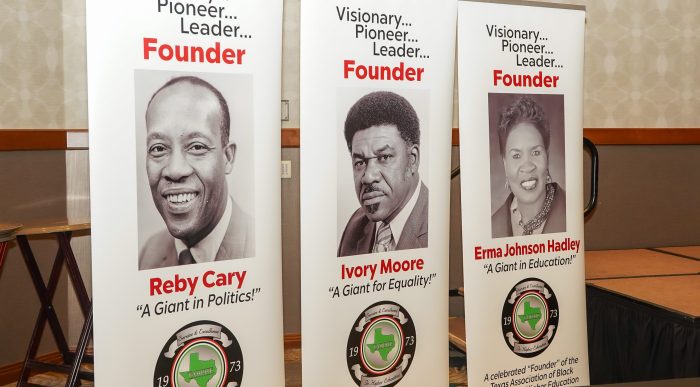 Vertical floor banners portray the three founders of the Texas Association of Black Personnel in Higher Education.