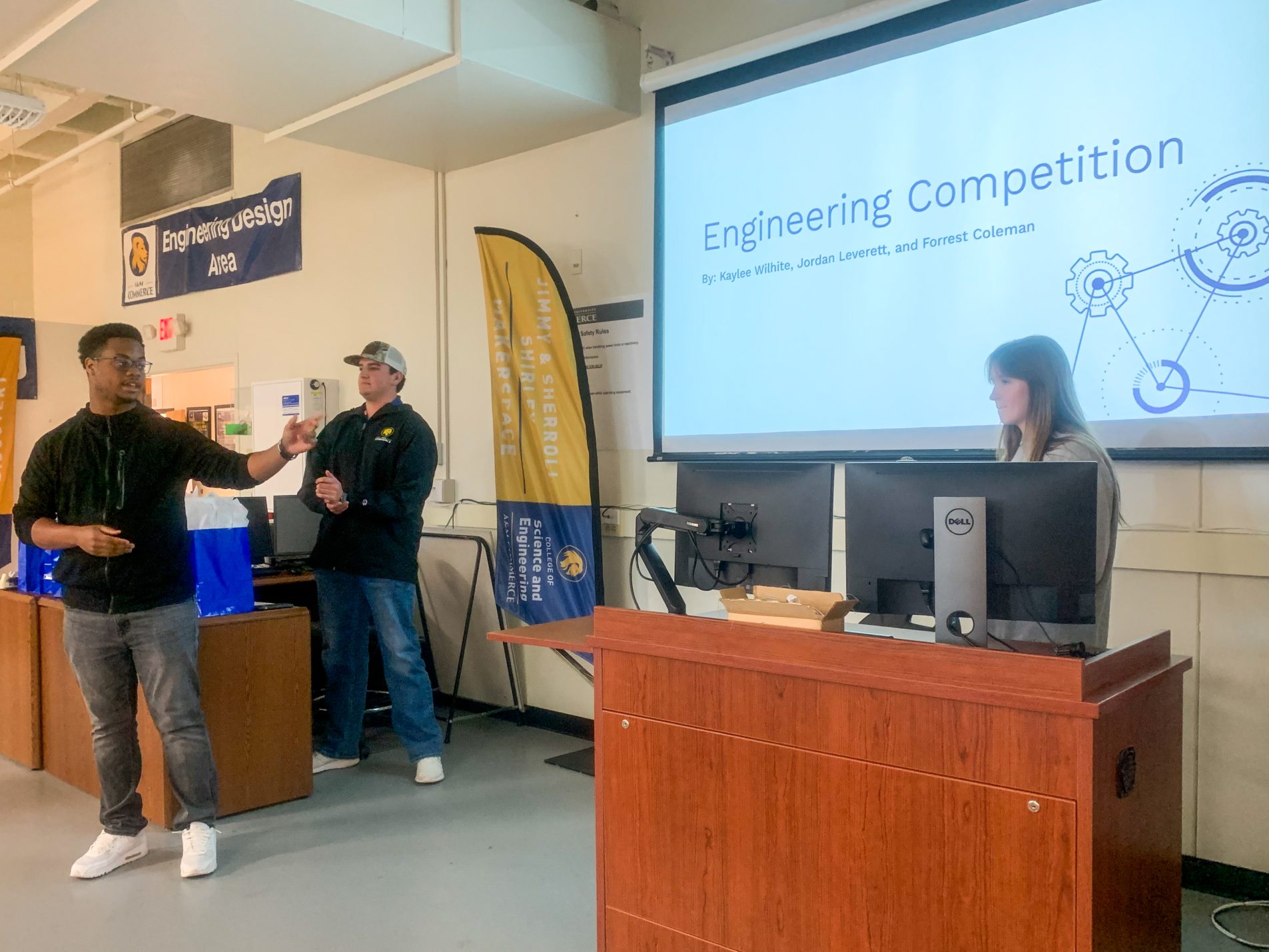 Three students present their entry in a recent engineering competition.