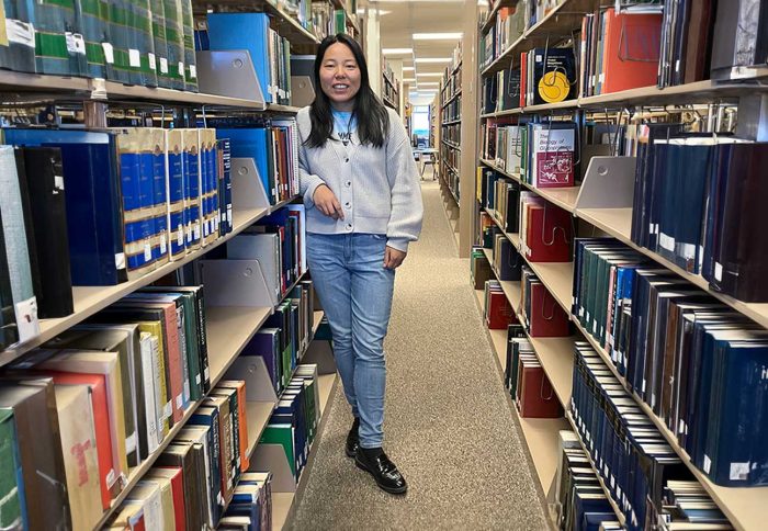 A female in the library aisle.